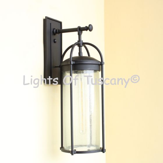 Wrought iron wall light,
Seeded glass outdoor light,
Black outdoor wall sconce,
Contemporary exterior lighting
Cylinder lantern wall mount
Outdoor lighting fixture,
Patio wall light,
Entryway wall lantern,
Sleek minimalist wall light,
Industrial-